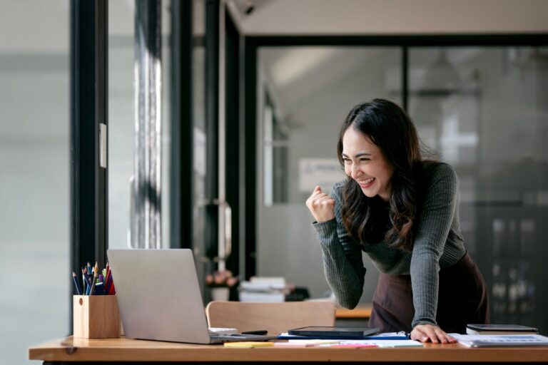 a woman looking at a laptop
